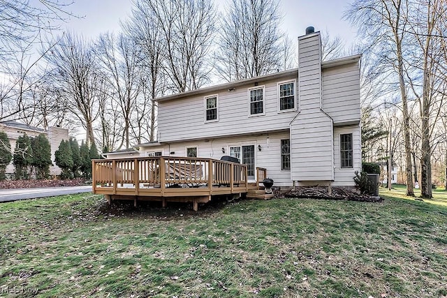 rear view of property with a yard and a wooden deck