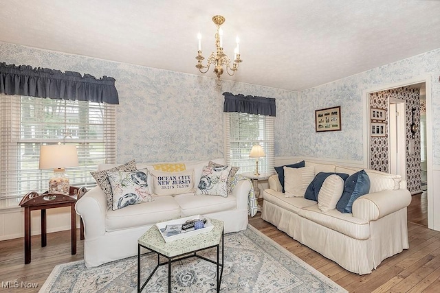 living room featuring hardwood / wood-style floors and an inviting chandelier