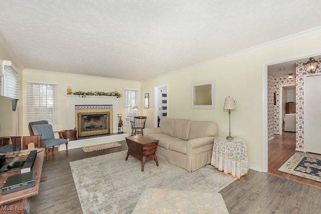 living room with dark hardwood / wood-style flooring, ornamental molding, and a textured ceiling