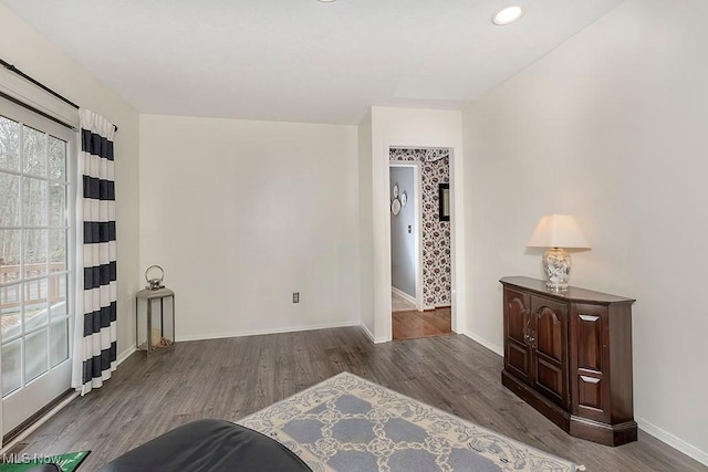 spare room with dark hardwood / wood-style floors and a healthy amount of sunlight