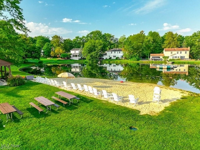 view of home's community featuring a yard and a water view