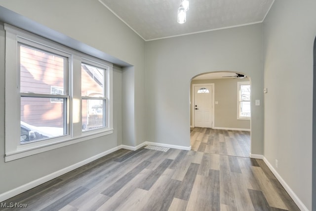 spare room with hardwood / wood-style flooring, ceiling fan, and crown molding