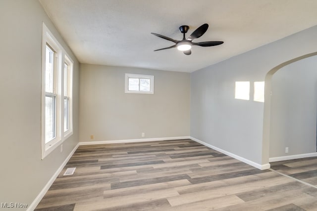 empty room featuring wood-type flooring and ceiling fan