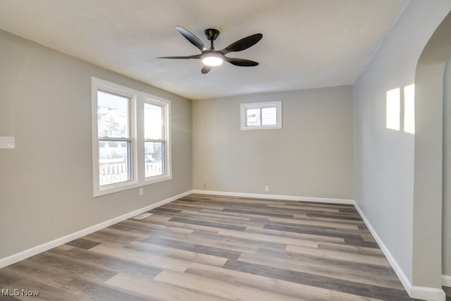 empty room featuring wood-type flooring and ceiling fan