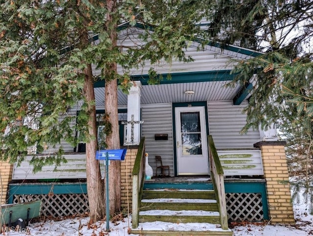 view of snow covered property entrance