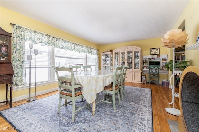 dining space with hardwood / wood-style flooring