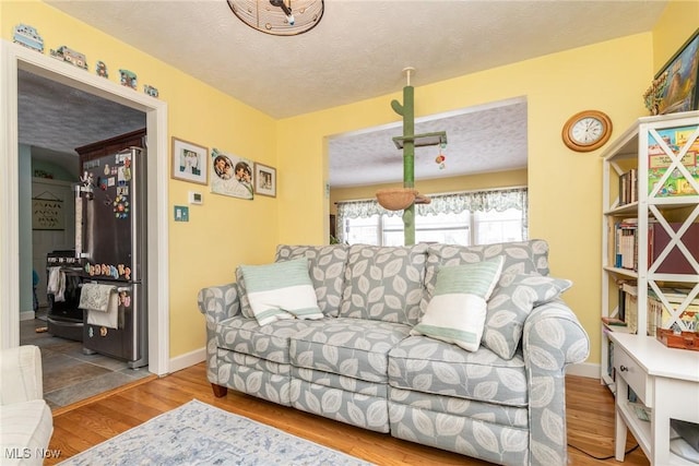 living room with hardwood / wood-style floors and a textured ceiling