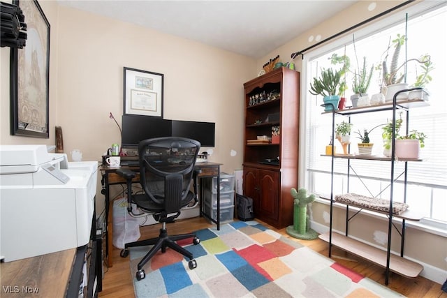 home office with light hardwood / wood-style flooring