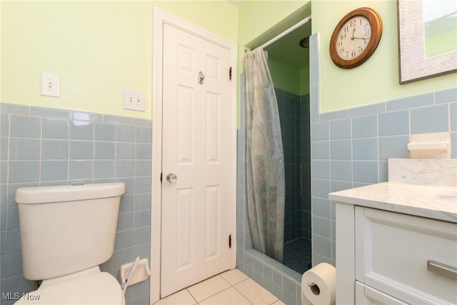 bathroom with a shower with shower curtain, vanity, tile walls, tile patterned flooring, and toilet