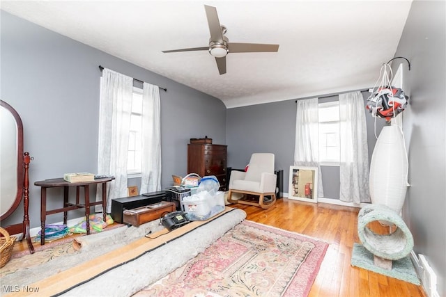 living area featuring light wood-type flooring and ceiling fan