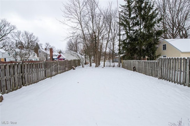 view of yard layered in snow