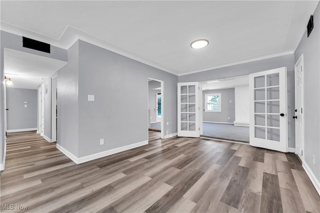 empty room with hardwood / wood-style flooring and french doors