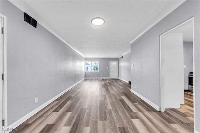 interior space with hardwood / wood-style flooring and crown molding