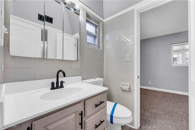 bathroom with decorative backsplash, vanity, tile walls, and toilet