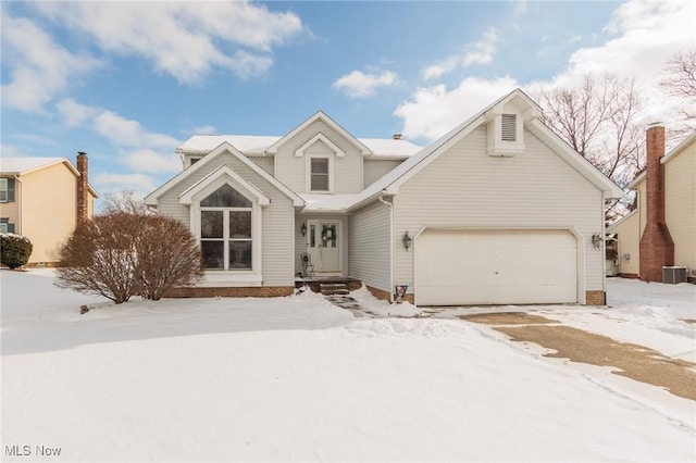 view of front of home featuring central AC and a garage