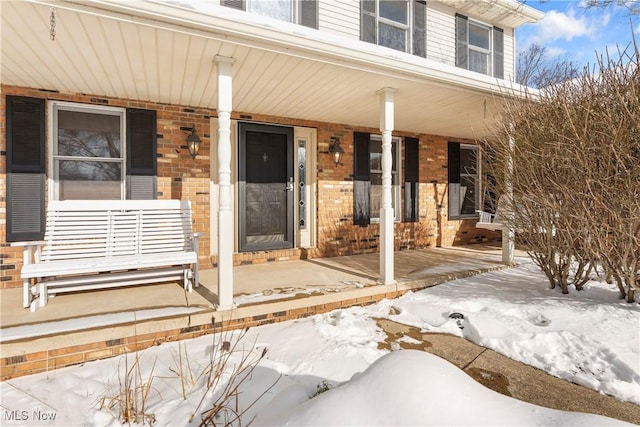 view of snow covered property entrance