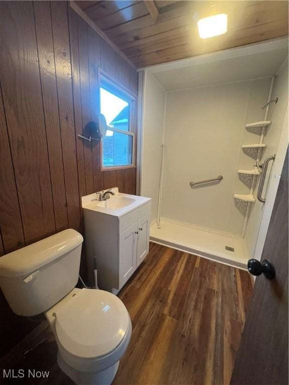 bathroom featuring walk in shower, wood walls, wood-type flooring, vanity, and wood ceiling