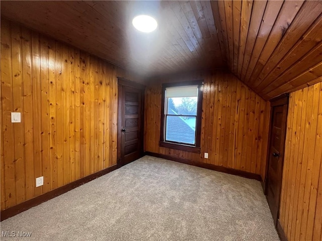 additional living space featuring carpet flooring, wood walls, lofted ceiling, and wood ceiling