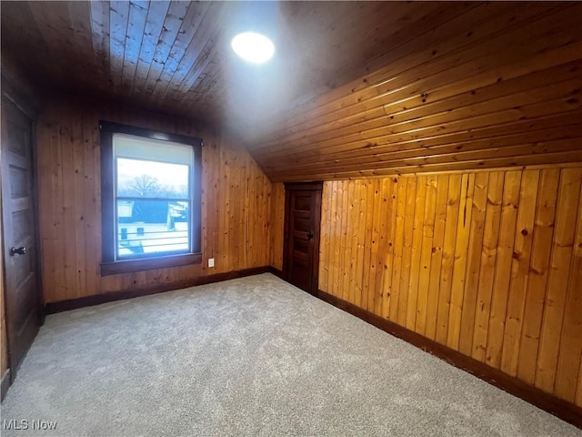 additional living space with carpet, wooden walls, lofted ceiling, and wood ceiling