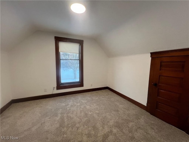 bonus room featuring carpet and vaulted ceiling