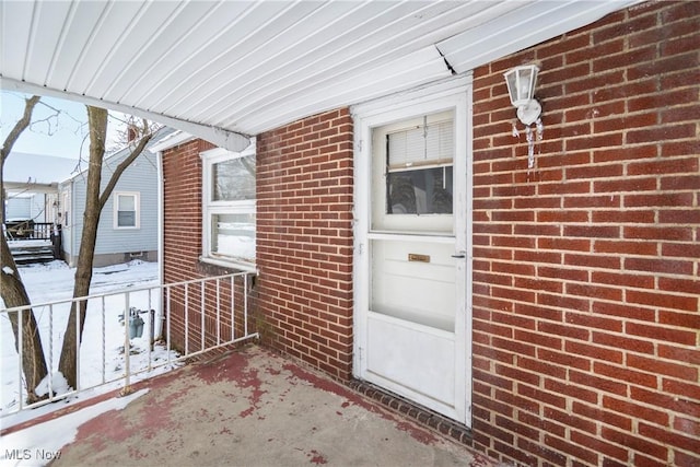 view of snow covered property entrance