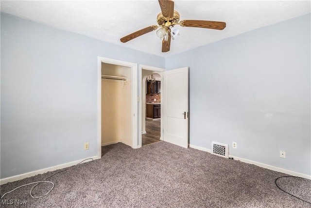 unfurnished bedroom with carpet floors, a closet, and ceiling fan