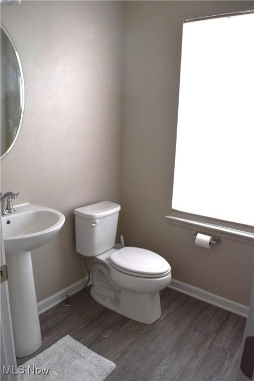 bathroom featuring hardwood / wood-style flooring, toilet, and sink