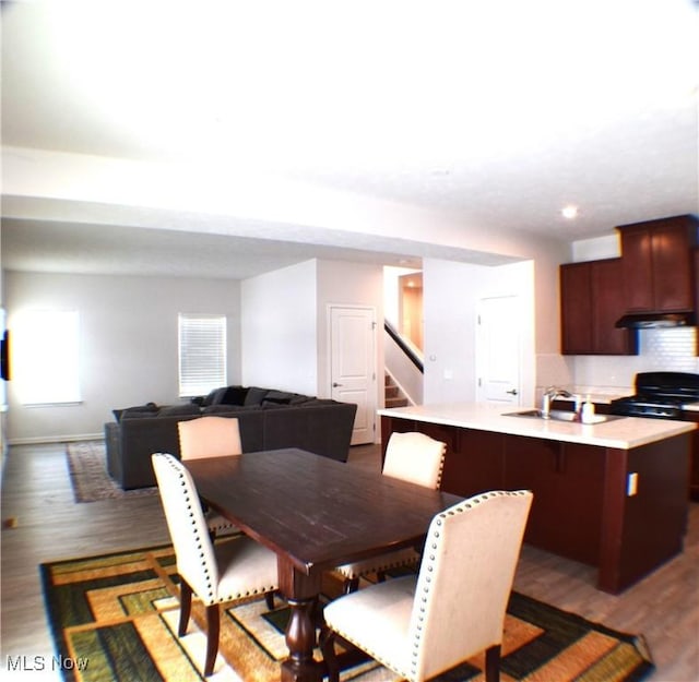 dining room featuring dark hardwood / wood-style flooring and sink