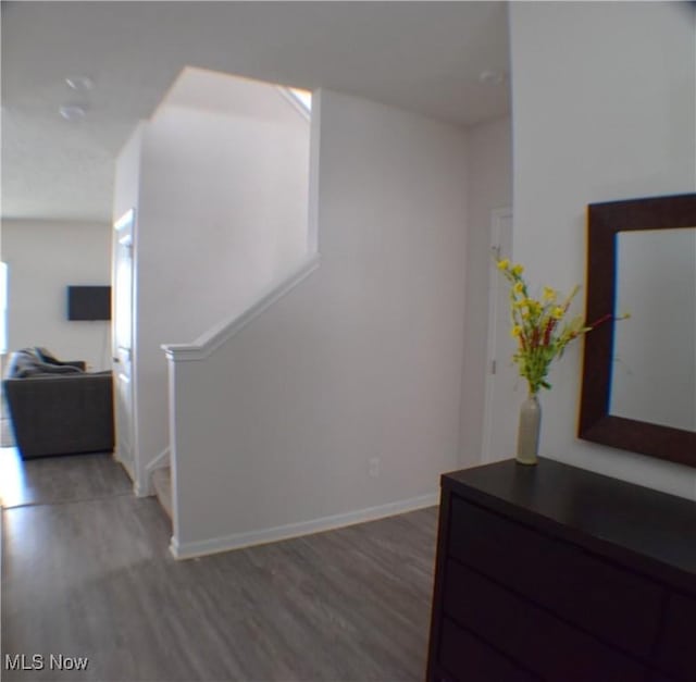 hallway with hardwood / wood-style flooring