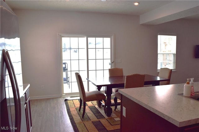 dining space with hardwood / wood-style floors