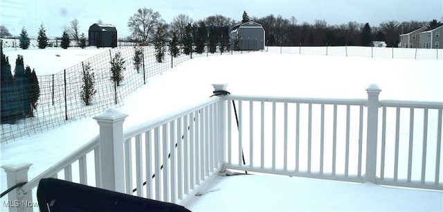 view of snow covered back of property