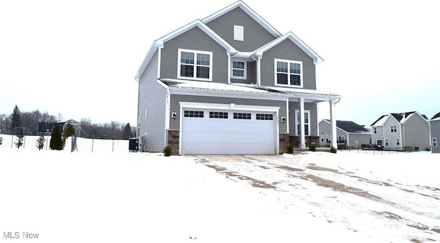 view of front facade featuring a garage and central air condition unit