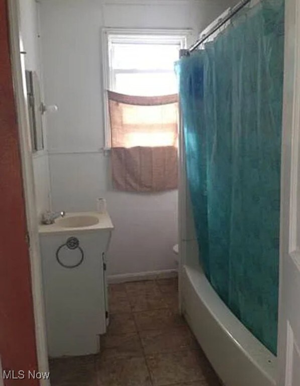 bathroom with vanity and shower / tub combo