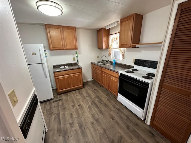 kitchen featuring white refrigerator, dark hardwood / wood-style flooring, electric stove, and sink