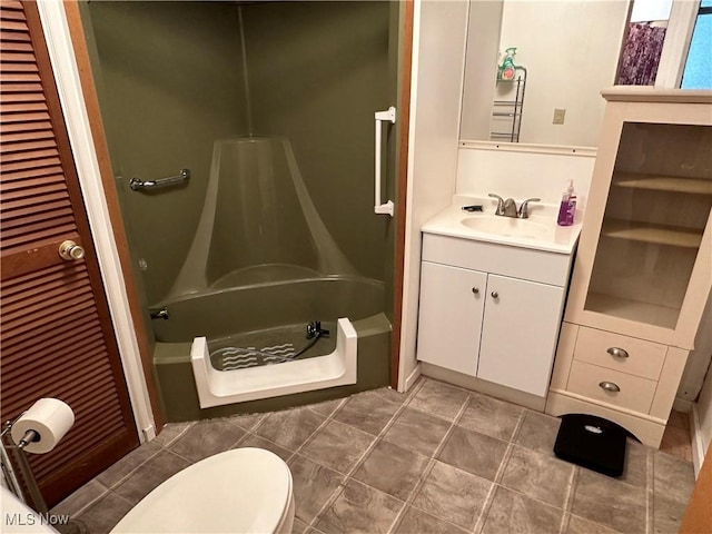 bathroom featuring toilet and vanity