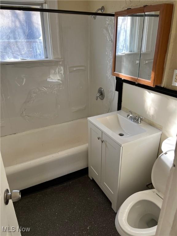 full bathroom featuring bathtub / shower combination, vanity, and toilet