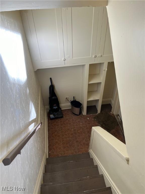 staircase featuring tile patterned flooring