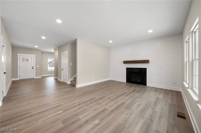 unfurnished living room featuring light hardwood / wood-style flooring