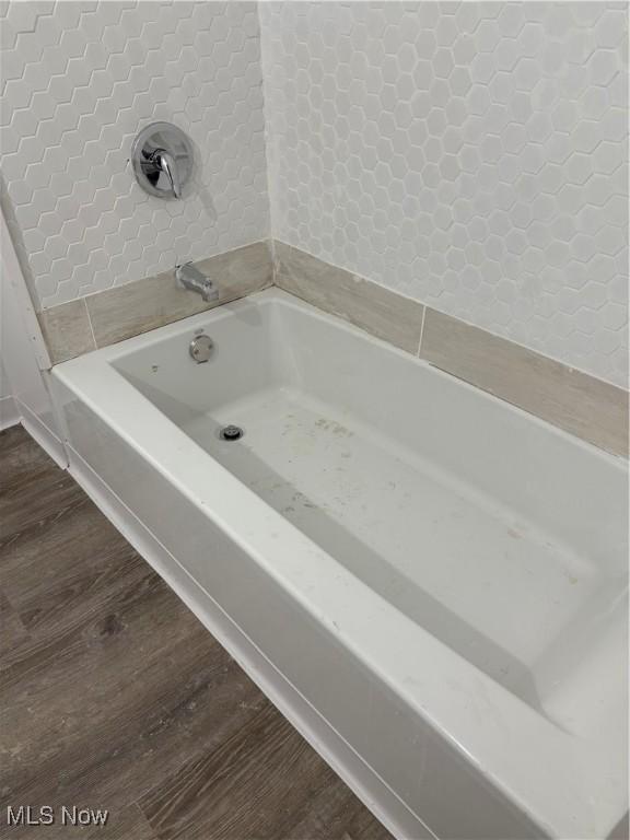 bathroom featuring a bathing tub and wood finished floors