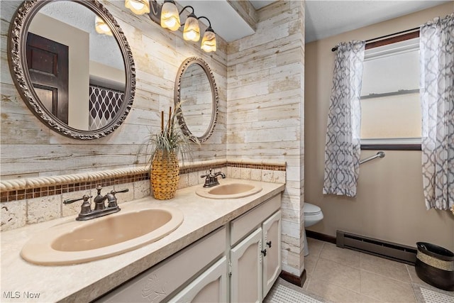 bathroom with vanity, a baseboard heating unit, tile patterned flooring, toilet, and a textured ceiling