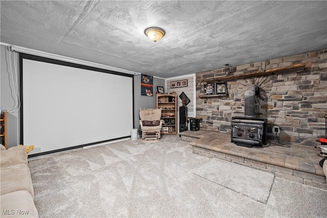 home theater with carpet flooring and a wood stove