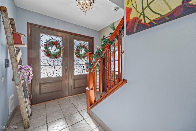 entrance foyer with a chandelier and french doors