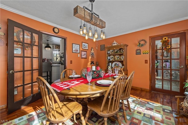 dining room with hardwood / wood-style flooring and ornamental molding