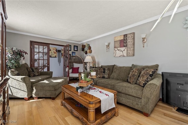 living room with light hardwood / wood-style flooring and crown molding