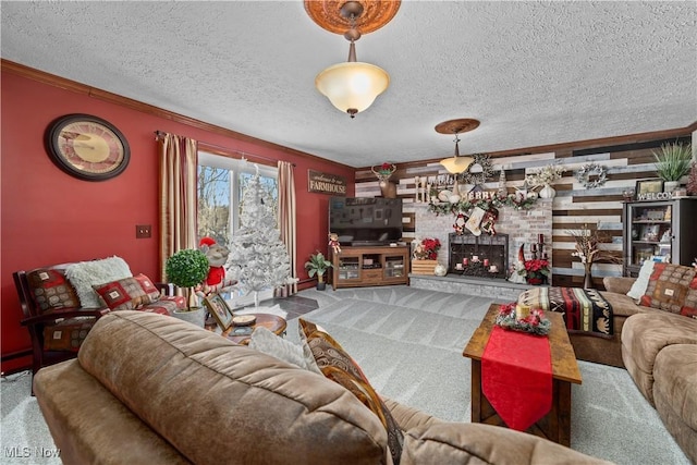 carpeted living room featuring a textured ceiling and a fireplace