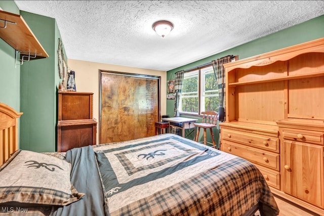 bedroom featuring a textured ceiling and hardwood / wood-style flooring