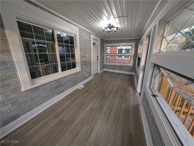 unfurnished sunroom with plenty of natural light and wood ceiling