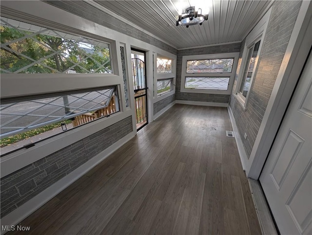 unfurnished sunroom with wooden ceiling and a chandelier