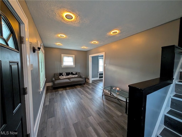 foyer featuring a textured ceiling and dark hardwood / wood-style floors