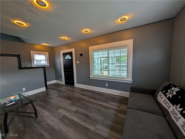 entryway with dark hardwood / wood-style floors and a textured ceiling